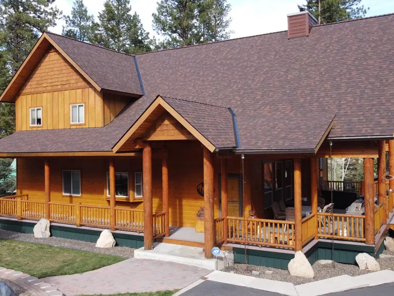 Brown shingle roof on a wood-sided home