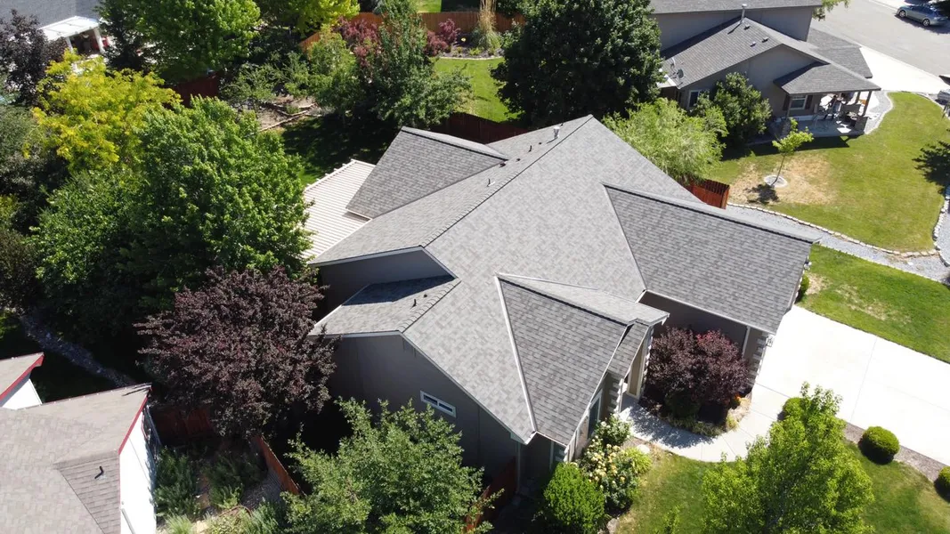 Aerial view of a completed gray shingle roof featured by Rebel Roofing
